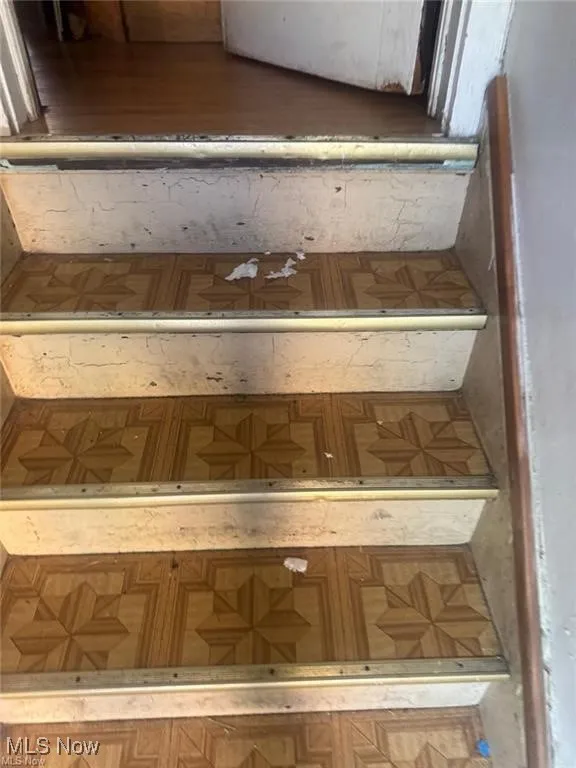 Stairway featuring parquet flooring