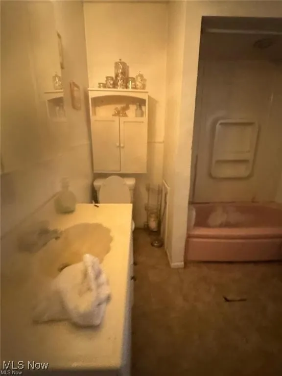 Full bathroom featuring vanity and toilet