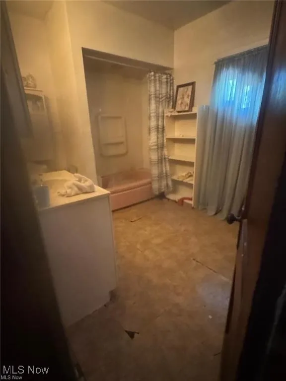 Bathroom with shower / bath combo and vanity