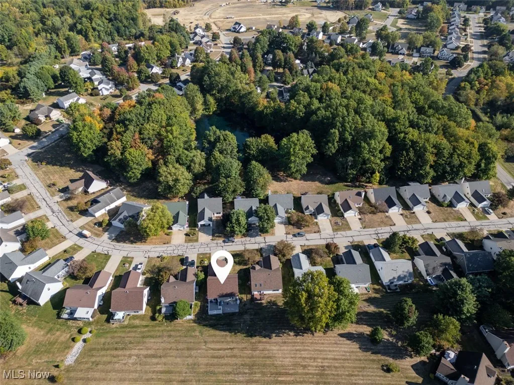 View of property location with nearby suburban area and a tree filled landscape