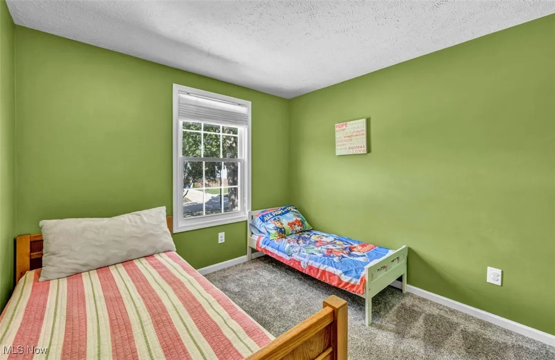 Bedroom with carpet and a textured ceiling
