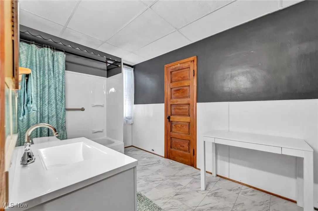 Bathroom with a drop ceiling and vanity