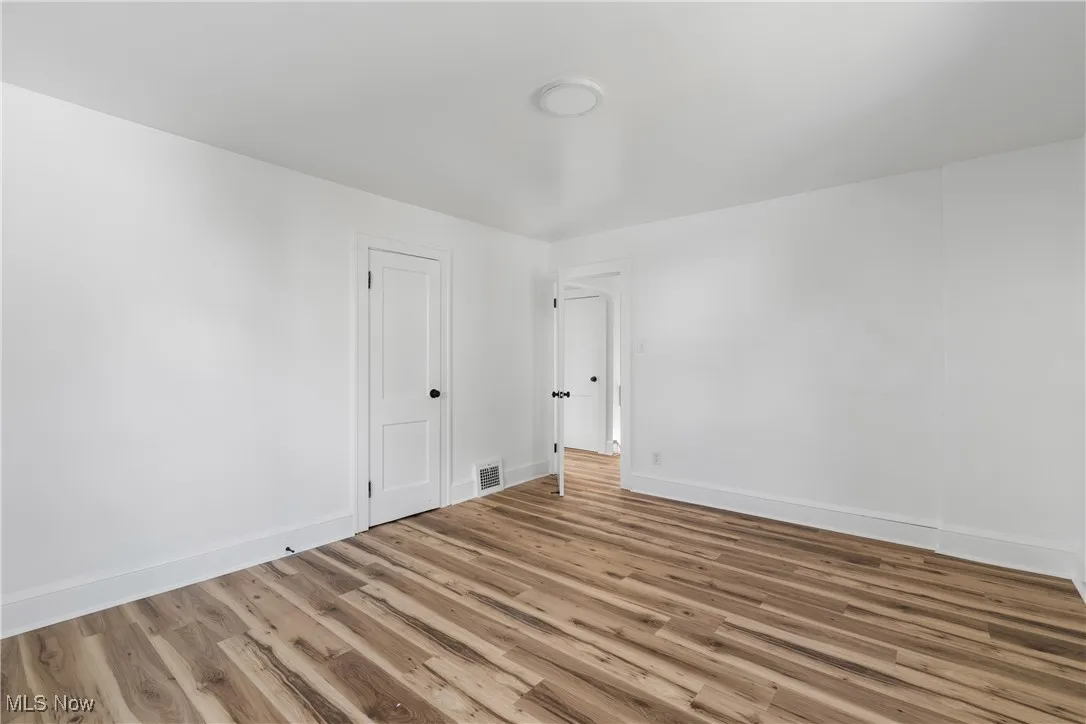 Bedroom featuring wood finished floors and baseboards