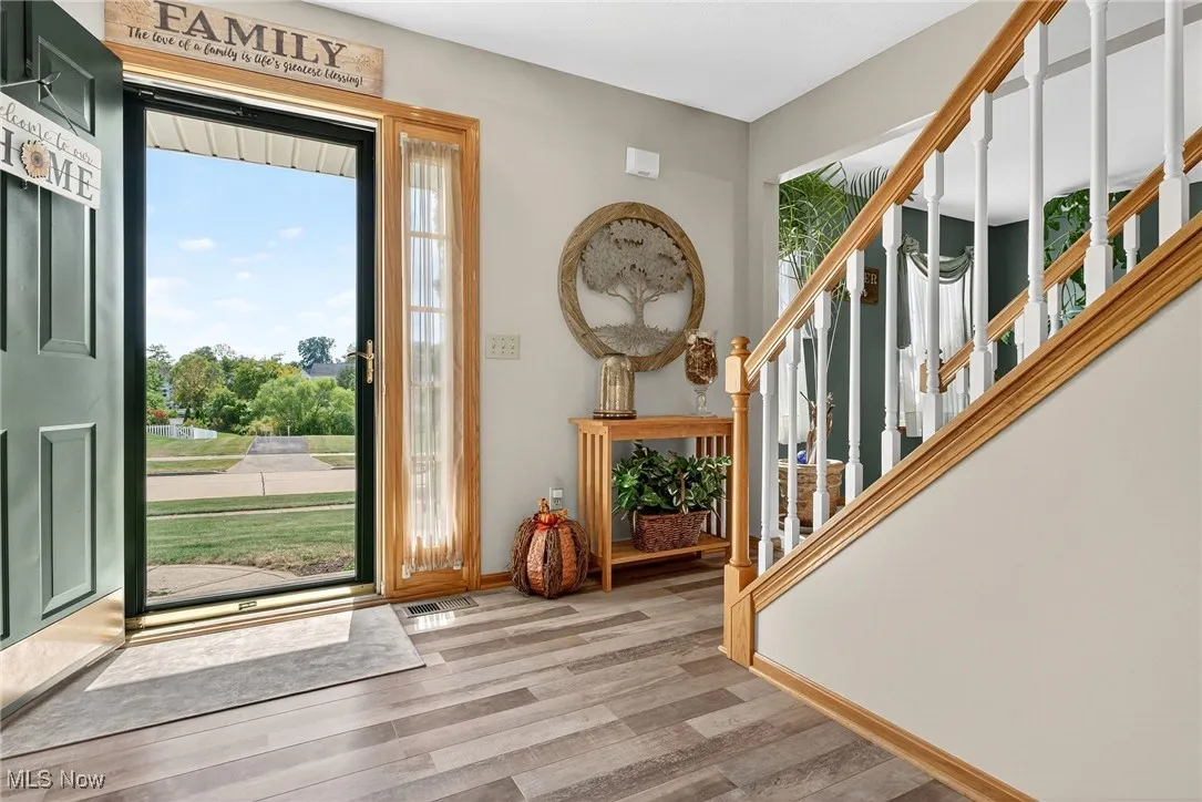 Entryway featuring wood finished floors and stairway