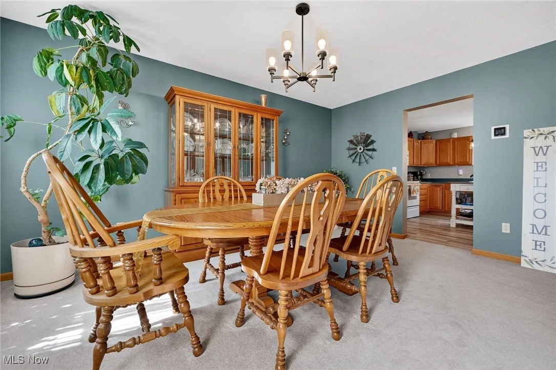 Dining room with a chandelier and light carpet