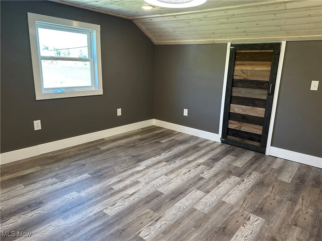 Bedroom 1 featuring wood finished floors, wood ceiling, and vaulted​​‌​​​​‌​​‌‌​‌‌​​​‌‌​‌​‌​‌​​​‌​​ ceiling