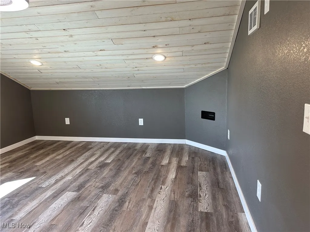 Bedroom 2 featuring wood ceiling, lofted ceiling, recessed lighting, dark wood-style flooring, and a textured wall