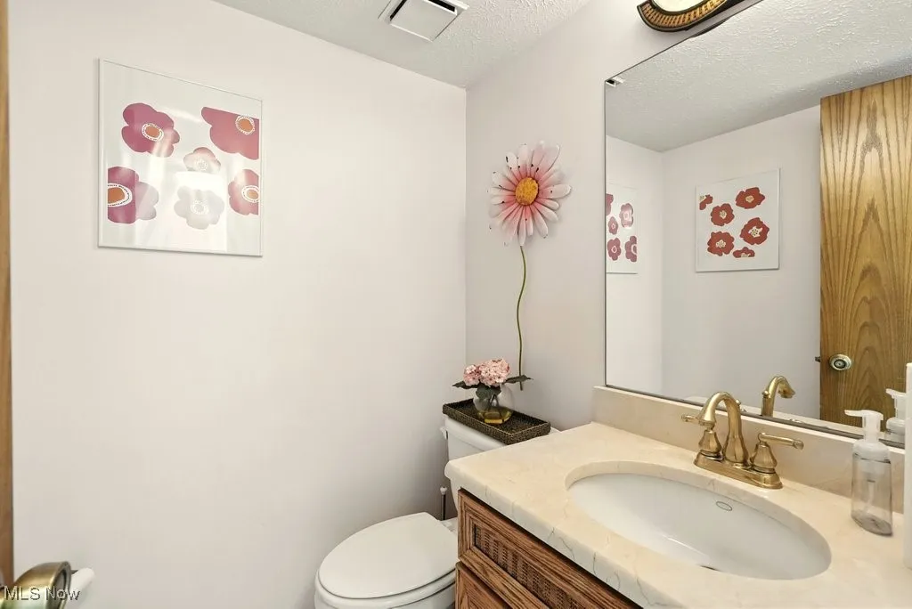 Bathroom featuring vanity and a textured ceiling