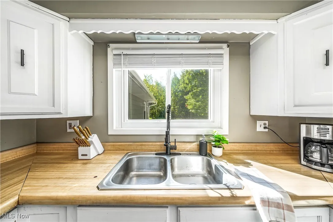 Kitchen with white cabinets and light countertops