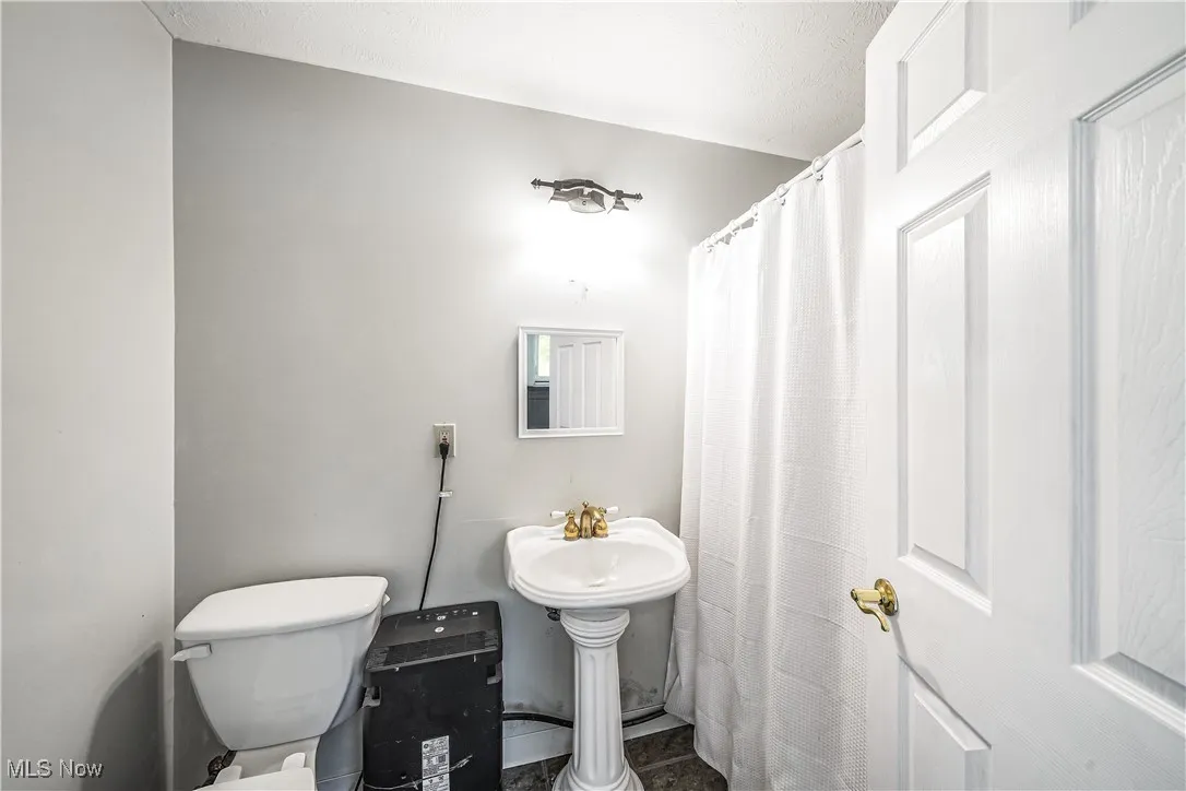 Bathroom featuring tile patterned flooring and a shower with curtain