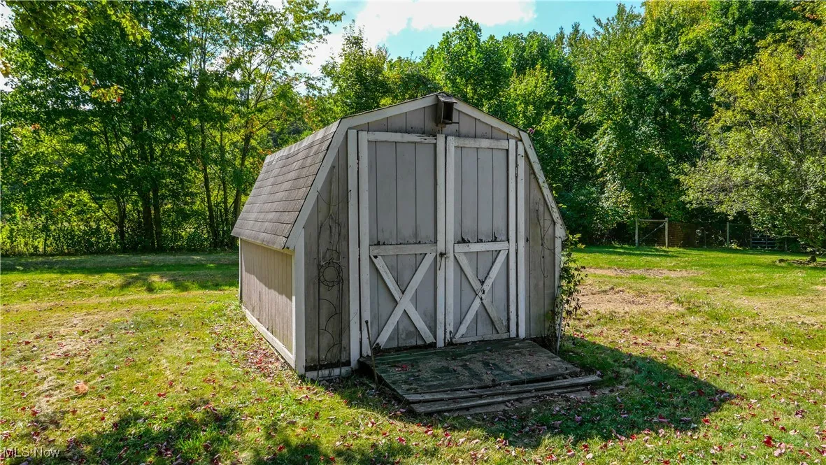 View of shed featuring view of scattered trees