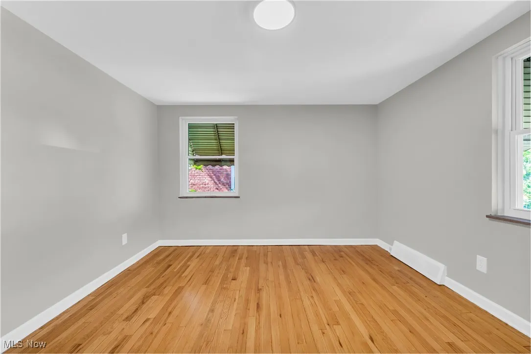 Spare room with light wood-style flooring and baseboards