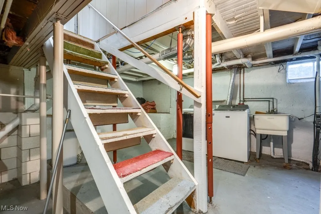 Basement featuring stairs and washer / dryer