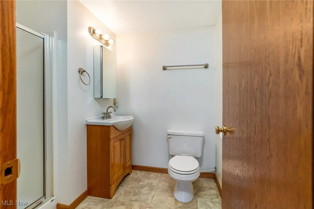 Full bathroom with a stall shower and vanity