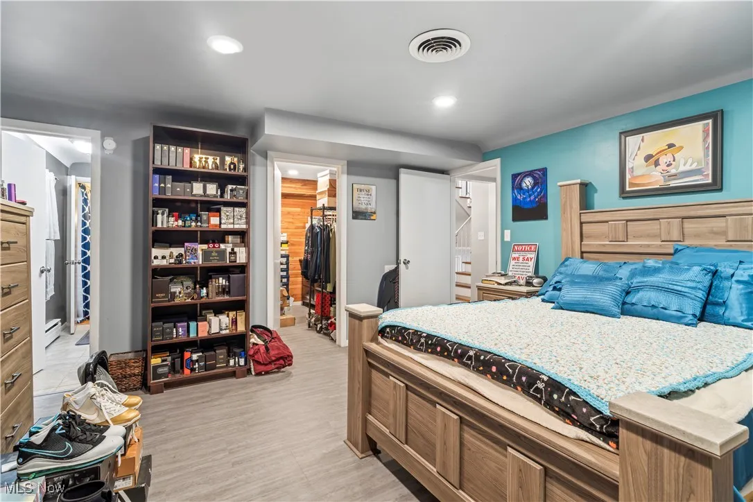 Bedroom featuring a spacious closet and recessed lighting