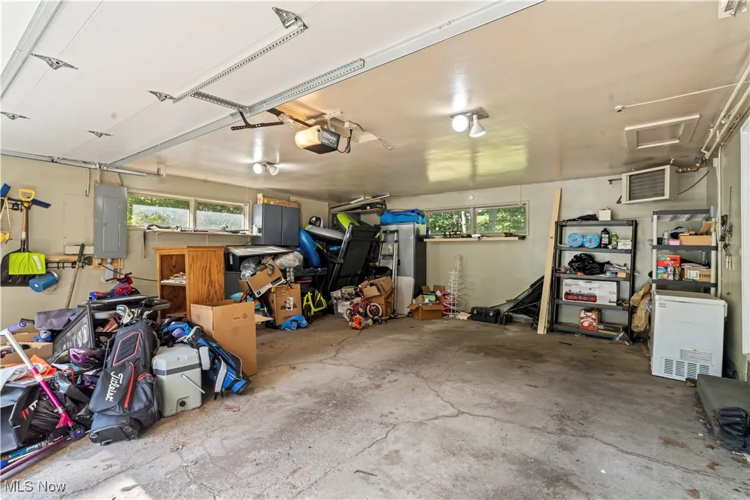 Garage with electric panel and a garage door opener