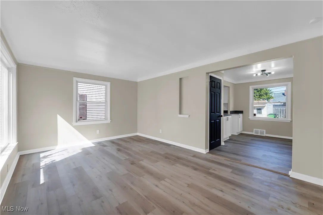 Unfurnished room featuring wood finished floors and crown molding