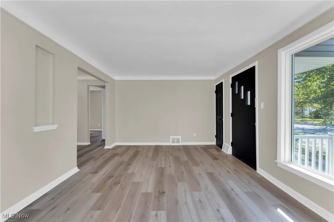 Empty room featuring light wood finished floors and baseboards