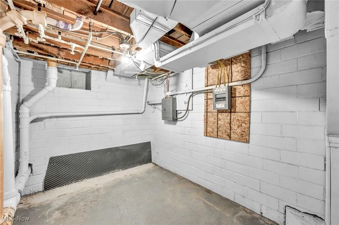 Unfinished basement with electric panel