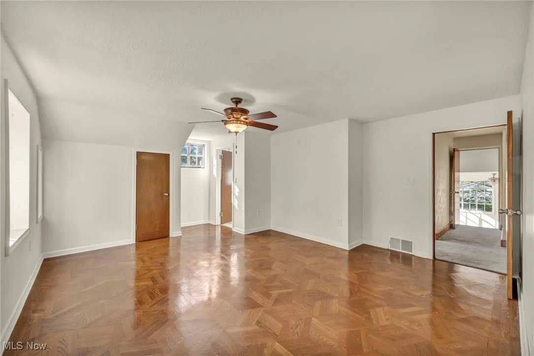Empty room featuring ceiling fan and a textured ceiling
