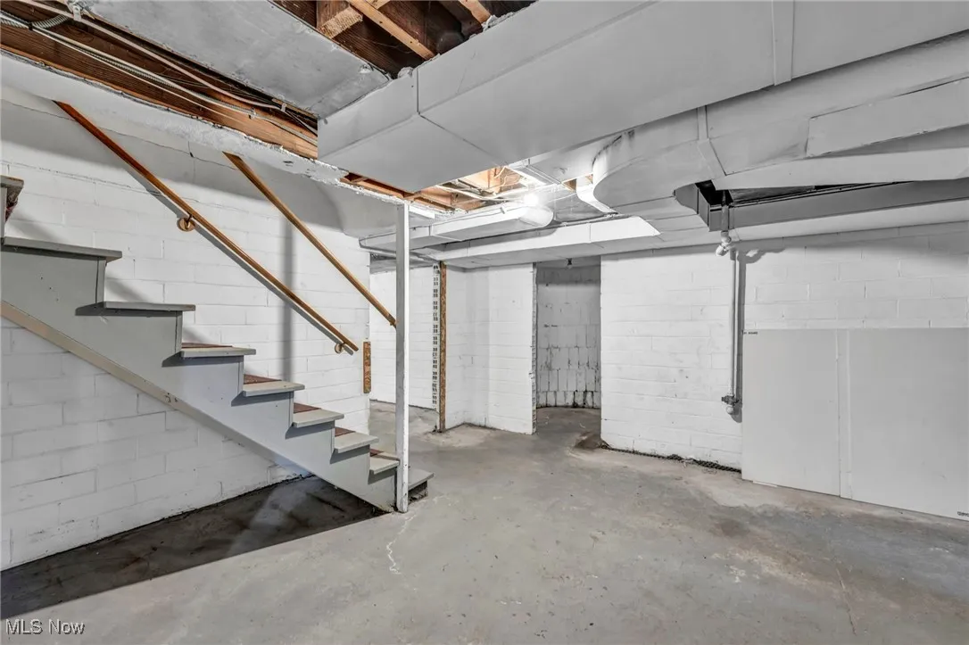 Unfinished below grade area featuring stairs