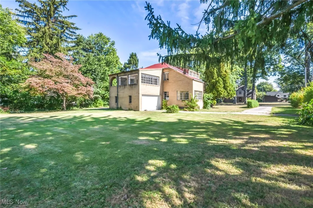 View of grassy yard with an attached garage