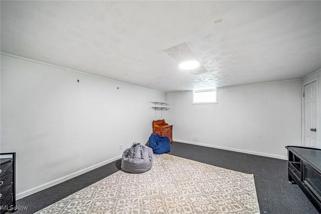 Playroom featuring dark carpet and a textured ceiling