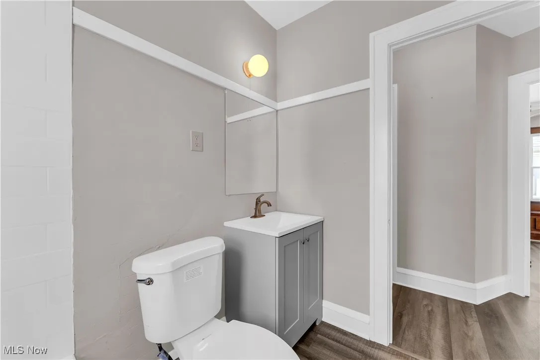 Bathroom featuring vanity and dark wood-type flooring