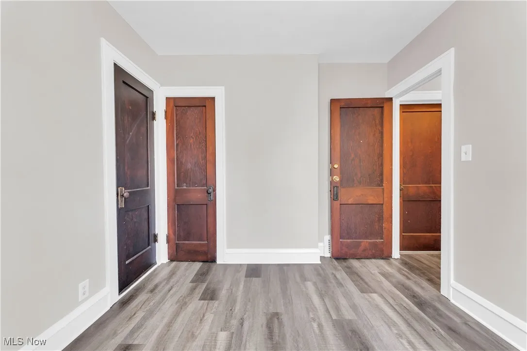 Unfurnished bedroom with light wood-style flooring and baseboards