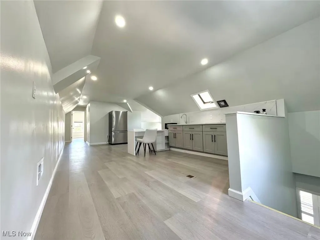 Bonus room featuring lofted ceiling, light wood-style flooring, recessed lighting, and a skylight