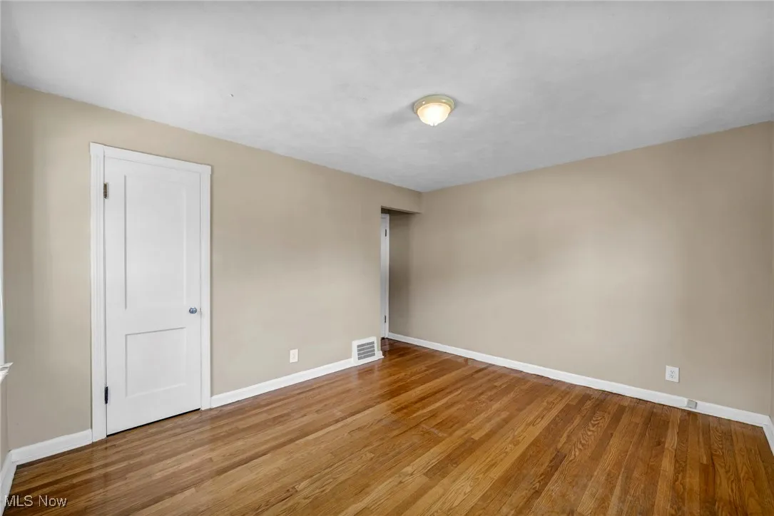 Empty room featuring baseboards and wood finished floors