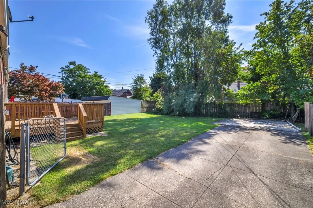 Fenced backyard featuring a deck