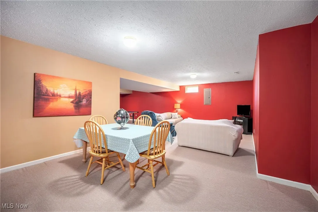 Dining area featuring carpet floors and a textured ceiling