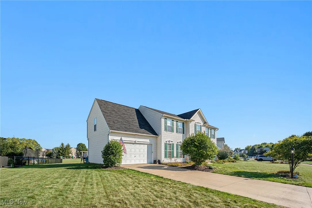 View of front of home featuring driveway and a shingled roof