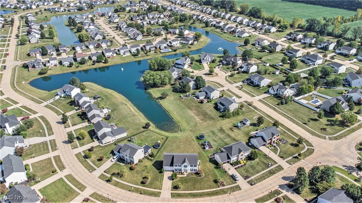 Aerial overview of property's location featuring a large body of water and nearby suburban area