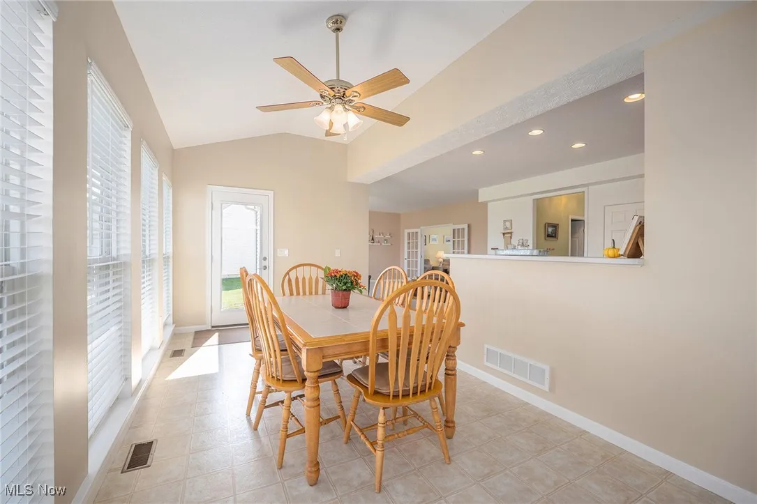 Dining room with vaulted ceiling, recessed lighting, and ceiling fan