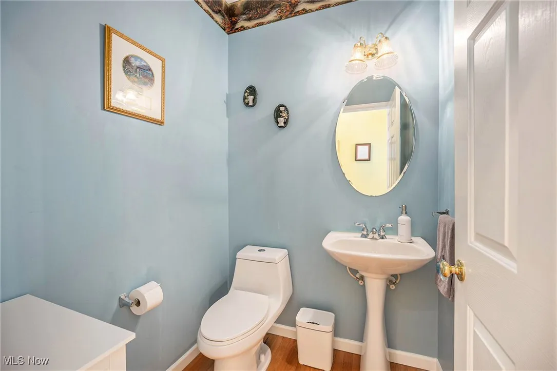 Bathroom featuring toilet and wood finished floors