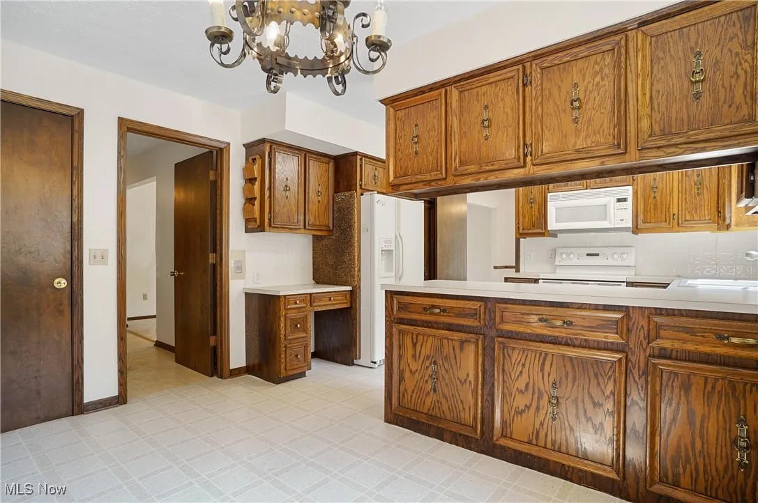 Kitchen eating area with door to hall and door to basement.