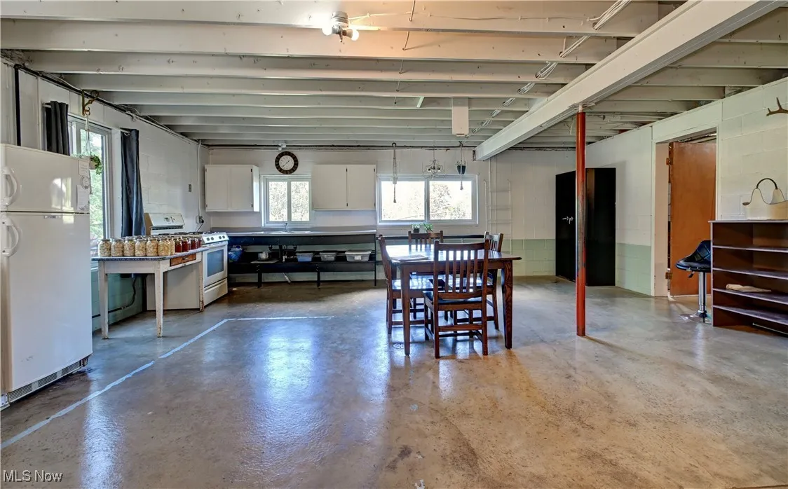 Dining room with concrete block wall and finished concrete floors