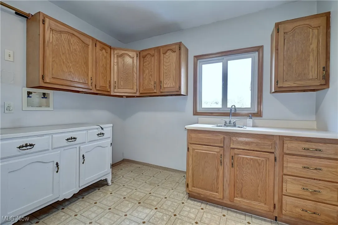 Washroom featuring light flooring and baseboards