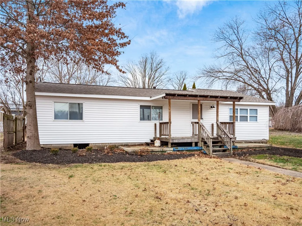 View of front of property with a shingled roof and a front yard