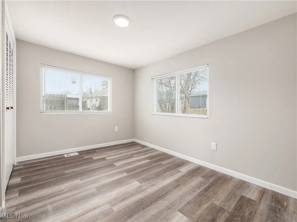 Unfurnished bedroom with a closet and light wood-style flooring