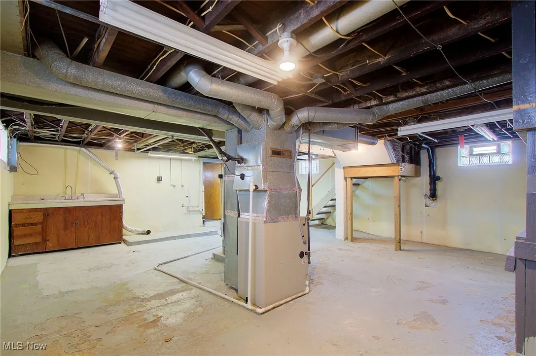 Basement with stairs and heating unit