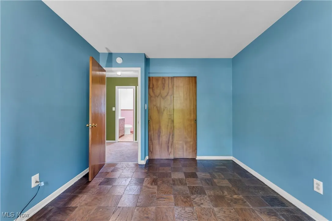 Unfurnished bedroom with baseboards and a closet