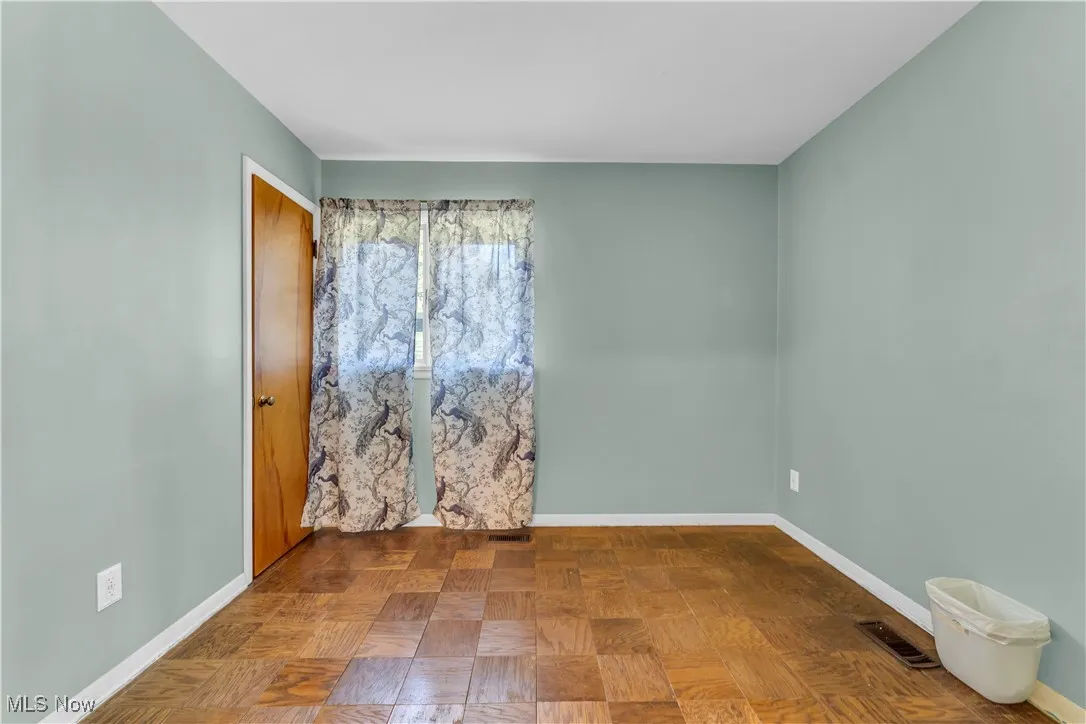 Unfurnished room with baseboards