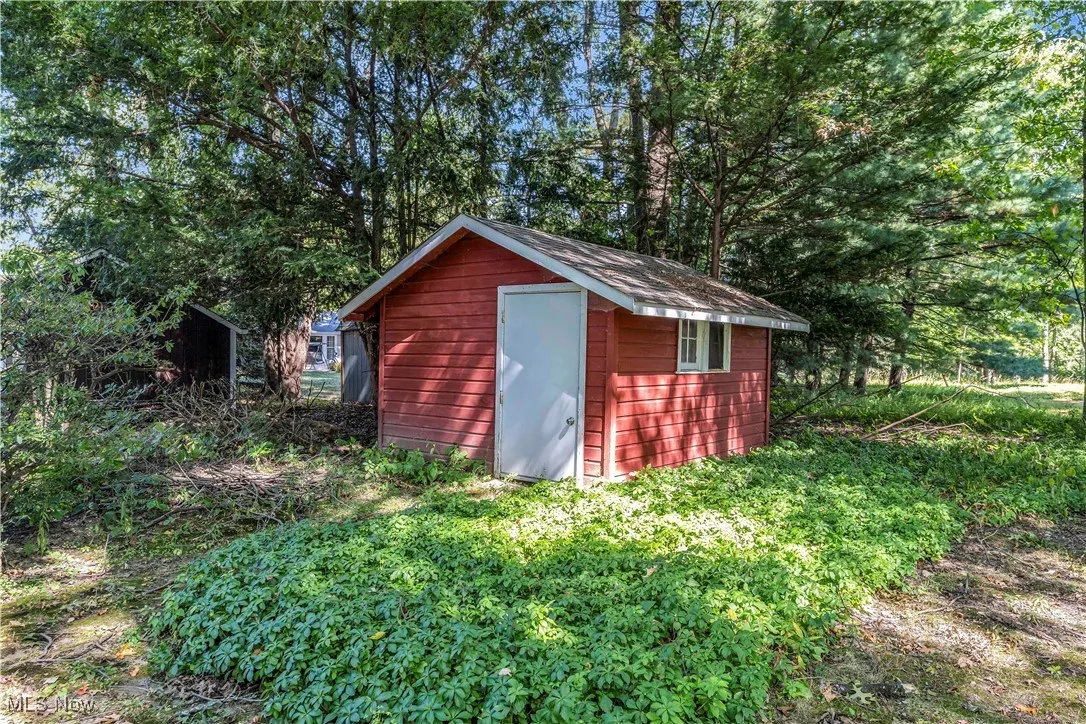 View of shed featuring view of wooded area