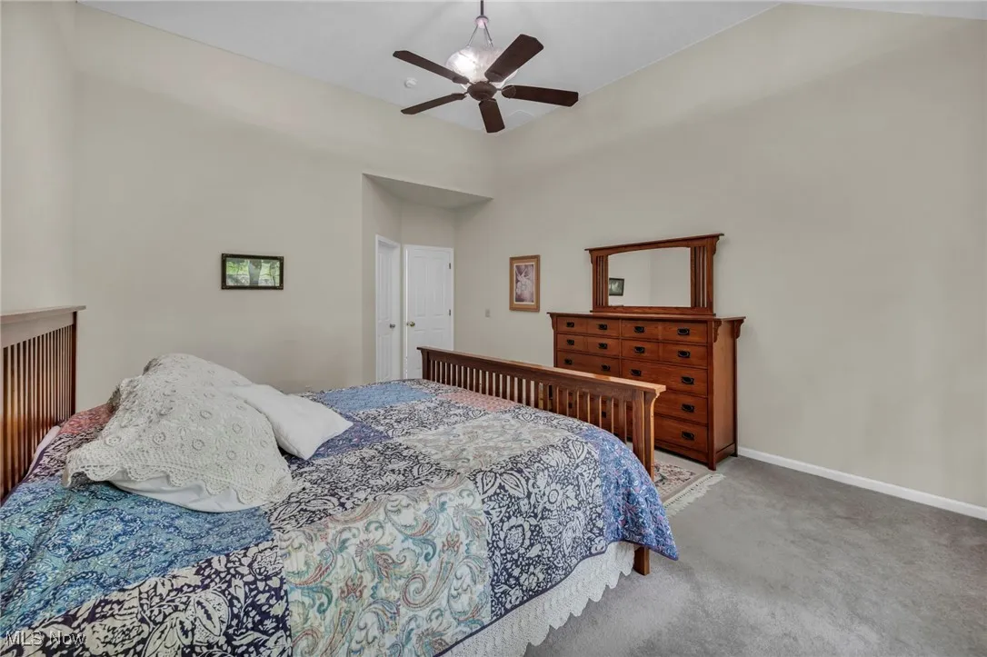 Bedroom featuring carpet floors, ceiling fan, and a closet