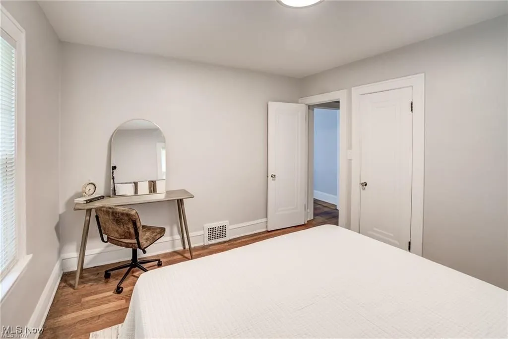 Bedroom featuring wood finished floors and baseboards