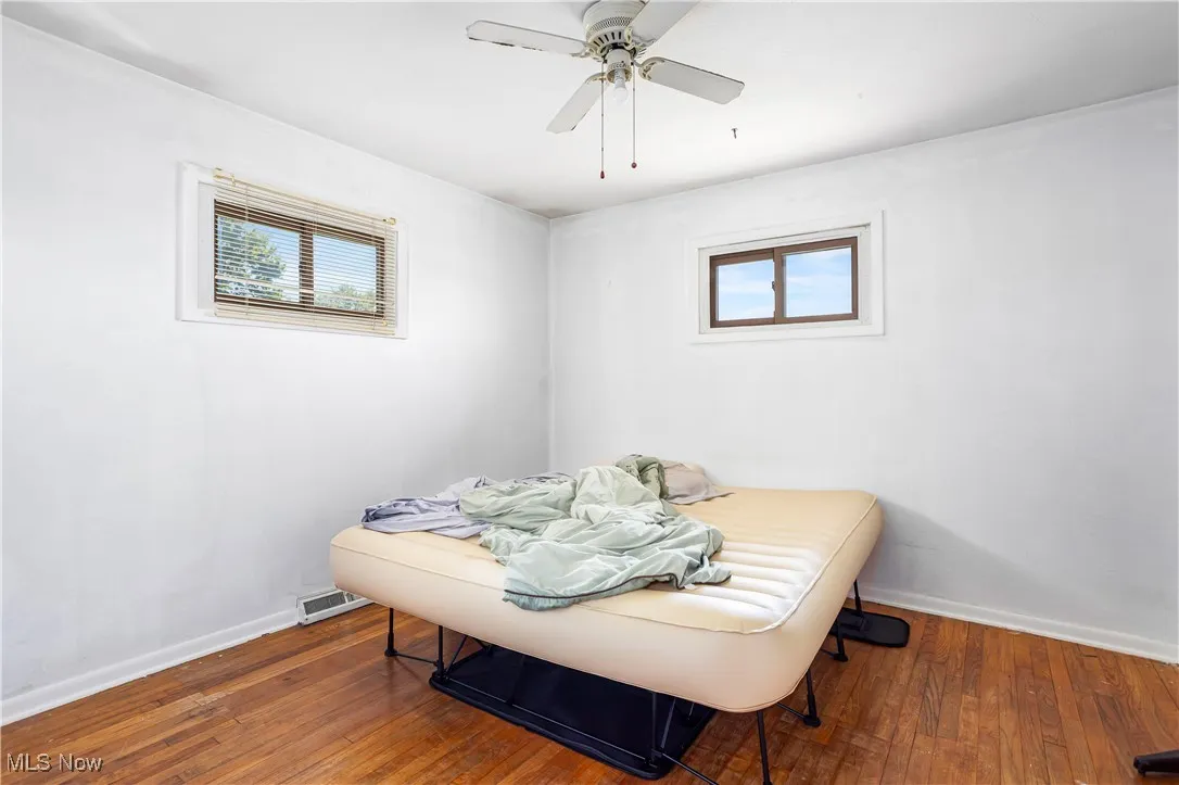 Bedroom with hardwood / wood-style flooring and ceiling fan