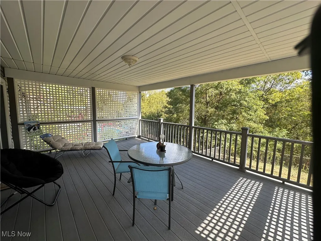 Wooden terrace featuring outdoor dining area